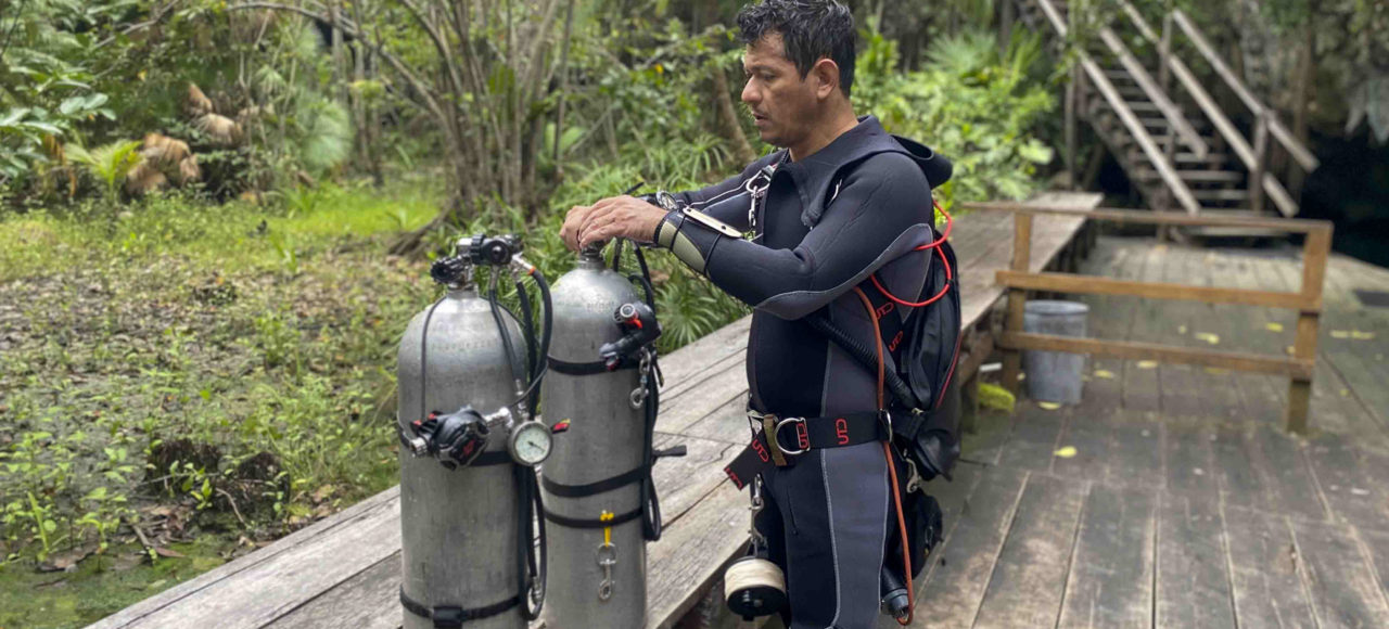Sidemount diver getting setup.