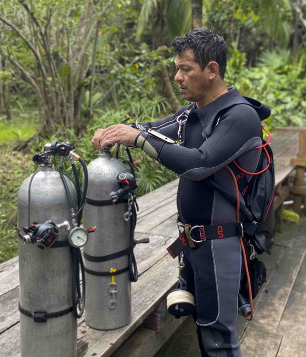 Sidemount diver getting setup.