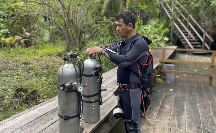 Sidemount diver getting setup.