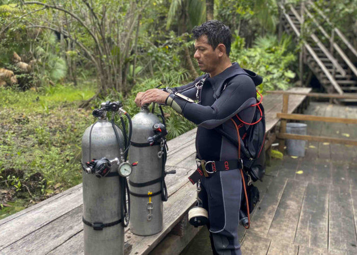 Sidemount diver getting setup.